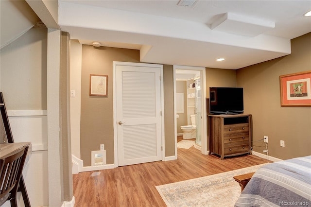 12671 Meadow Bridge Way, Parker, CO 80134 - bedroom featuring light wood finished floors, baseboards, ensuite bath, and recessed lighting