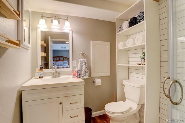 12671 Meadow Bridge Way, Parker, CO 80134 - bathroom with vanity, toilet, wood finished floors, and ensuite bath