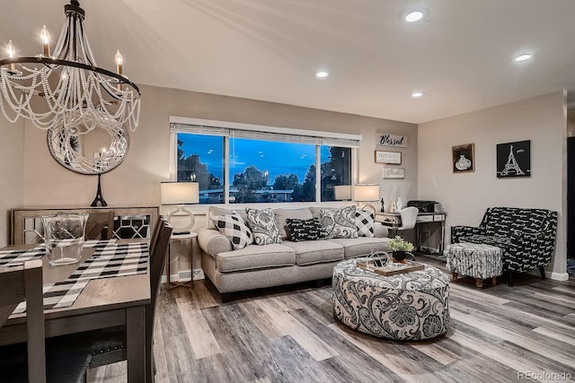 living room featuring recessed lighting, a notable chandelier, and wood finished floors