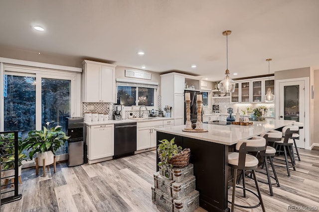 kitchen with tasteful backsplash, open shelves, fridge, white cabinets, and dishwashing machine