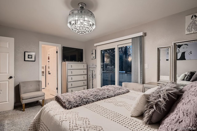 bedroom featuring carpet, a chandelier, connected bathroom, and access to exterior