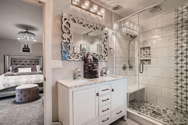 full bathroom featuring a sink, connected bathroom, and a stall shower