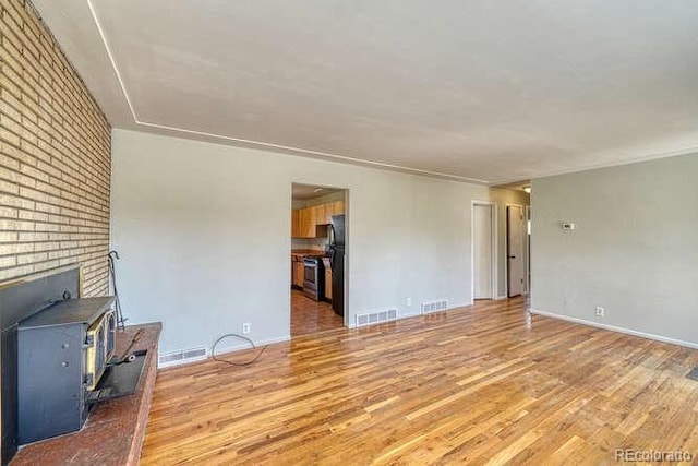 unfurnished living room with light hardwood / wood-style flooring