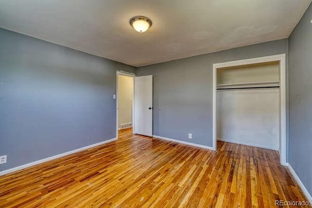 unfurnished bedroom featuring a closet and light hardwood / wood-style flooring