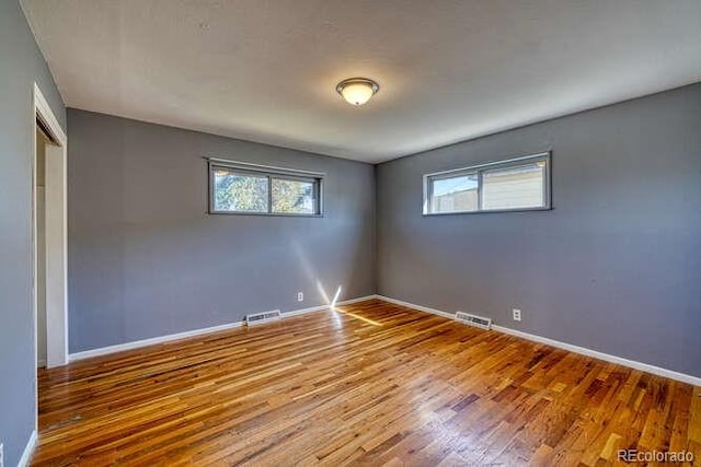 spare room featuring hardwood / wood-style flooring