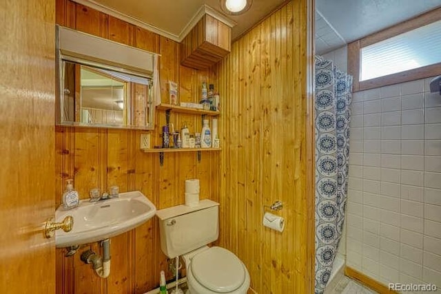 bathroom featuring wood walls, curtained shower, and toilet