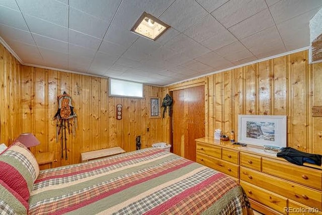 bedroom featuring wooden walls