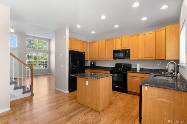 9898 Tourmaline Ct, Parker, CO 80134 - kitchen with black appliances, a sink, a kitchen island, baseboards, and recessed lighting