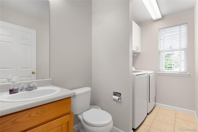 9898 Tourmaline Ct, Parker, CO 80134 - bathroom with washing machine and clothes dryer, toilet, vanity, tile patterned floors, and baseboards