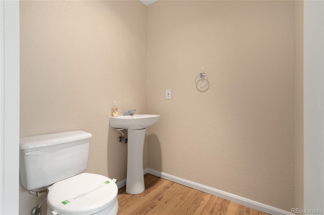 9898 Tourmaline Ct, Parker, CO 80134 - bathroom with toilet, wood finished floors, and baseboards