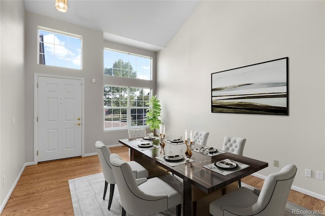 9898 Tourmaline Ct, Parker, CO 80134 - dining space featuring healthy amount of natural light, a towering ceiling, baseboards, and light wood-type flooring