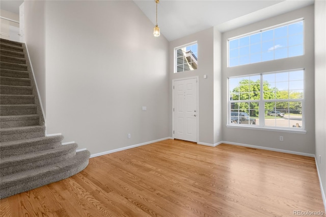 9898 Tourmaline Ct, Parker, CO 80134 - entryway with stairway, light wood-style flooring, high vaulted ceiling, and baseboards