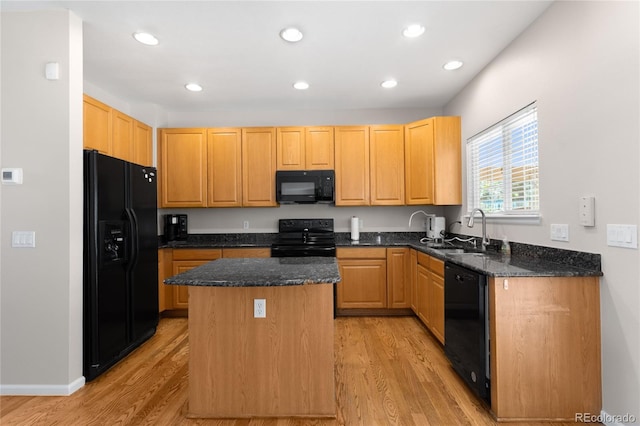 9898 Tourmaline Ct, Parker, CO 80134 - kitchen featuring black appliances, a sink, light wood-style floors, a center island, and dark stone countertops