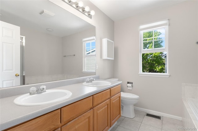 9898 Tourmaline Ct, Parker, CO 80134 - bathroom featuring double vanity, tiled bath, tile patterned flooring, baseboards, and toilet