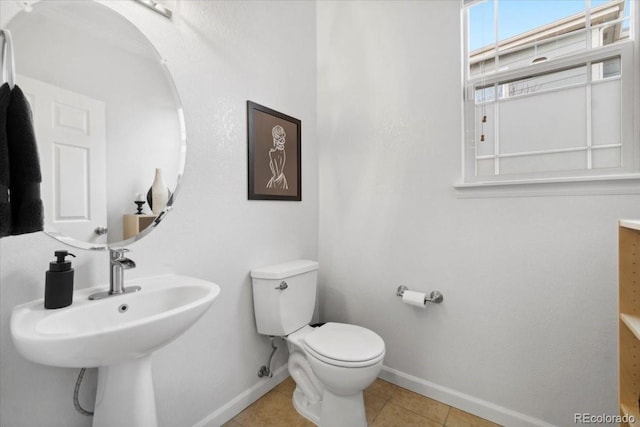 1761 S Buchanan Cir, Aurora, CO 80018 - half bathroom with toilet, baseboards, tile patterned flooring, and a sink
