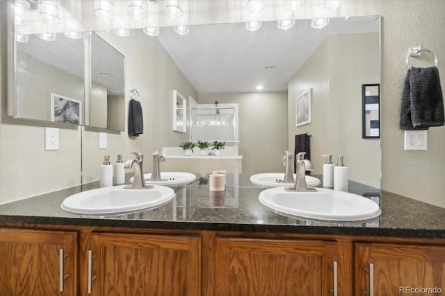 1761 S Buchanan Cir, Aurora, CO 80018 - bathroom featuring a sink, double vanity, and a textured wall