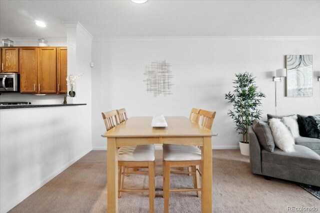 1761 S Buchanan Cir, Aurora, CO 80018 - dining space with ornamental molding, light carpet, and baseboards
