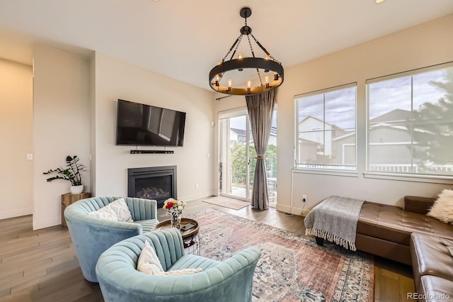 19 S 45th Ave, Brighton, CO 80601 - living room with an inviting chandelier, baseboards, wood-type flooring, and a glass covered fireplace