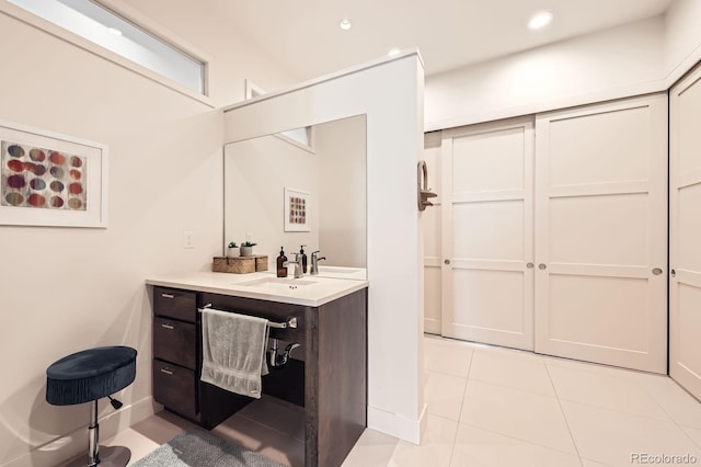 19 S 45th Ave, Brighton, CO 80601 - bathroom featuring vanity, tile patterned flooring, baseboards, and recessed lighting