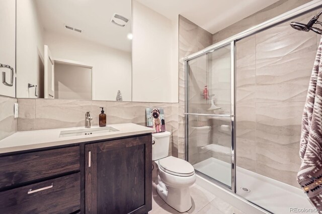 19 S 45th Ave, Brighton, CO 80601 - full bathroom featuring vanity, toilet, tile walls, visible vents, and a stall shower