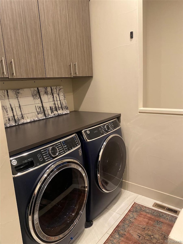 19 S 45th Ave, Brighton, CO 80601 - laundry area featuring independent washer and dryer, visible vents, tile patterned flooring, cabinet space, and baseboards