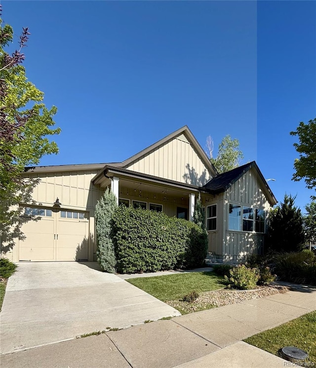 19 S 45th Ave, Brighton, CO 80601 - view of front of house with board and batten siding, a garage, and concrete driveway