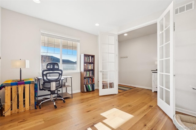 office area with wood-type flooring and french doors