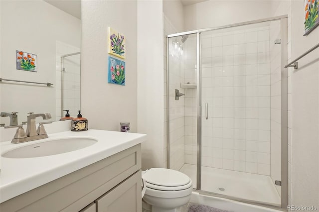 bathroom featuring vanity, an enclosed shower, and toilet