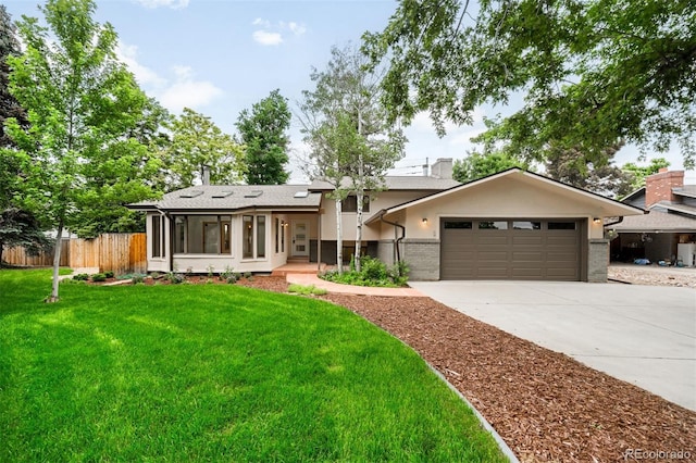 655 Cree Cir, Boulder, CO 80303 - split level home featuring a garage, a chimney, driveway, brick siding, and a sunroom