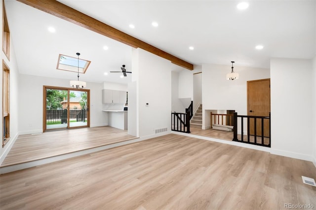 655 Cree Cir, Boulder, CO 80303 - unfurnished living room featuring recessed lighting, light wood finished floors, ceiling fan, stairs, and a chandelier