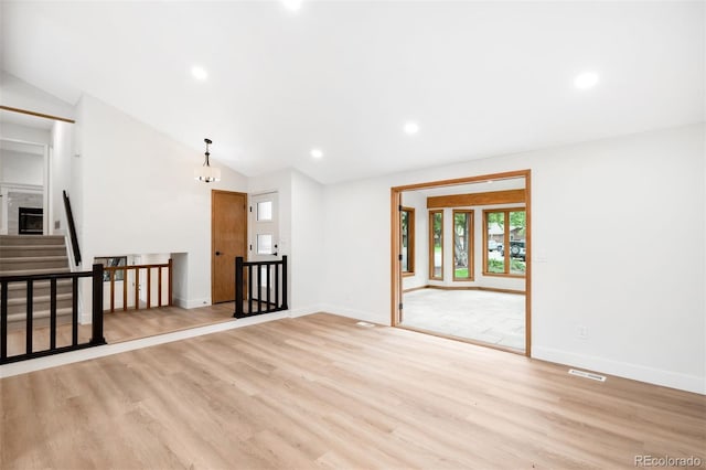 655 Cree Cir, Boulder, CO 80303 - empty room with light wood-style flooring, vaulted ceiling, recessed lighting, and stairway