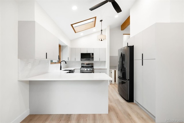 655 Cree Cir, Boulder, CO 80303 - kitchen with stainless steel appliances, vaulted ceiling, a peninsula, ceiling fan, and light countertops