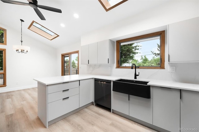 655 Cree Cir, Boulder, CO 80303 - kitchen featuring a skylight, dishwashing machine, a peninsula, light countertops, and recessed lighting