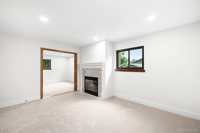655 Cree Cir, Boulder, CO 80303 - unfurnished living room with light carpet, a tiled fireplace, and recessed lighting
