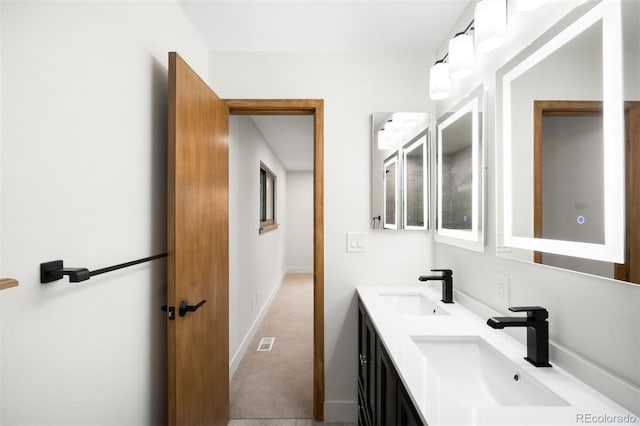 655 Cree Cir, Boulder, CO 80303 - bathroom featuring double vanity and baseboards