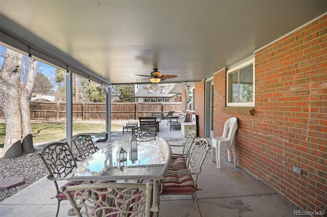 sunroom featuring ceiling fan