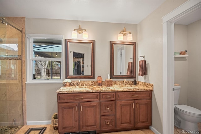 bathroom featuring an enclosed shower, vanity, and toilet