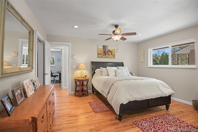 bedroom with ceiling fan and light hardwood / wood-style flooring