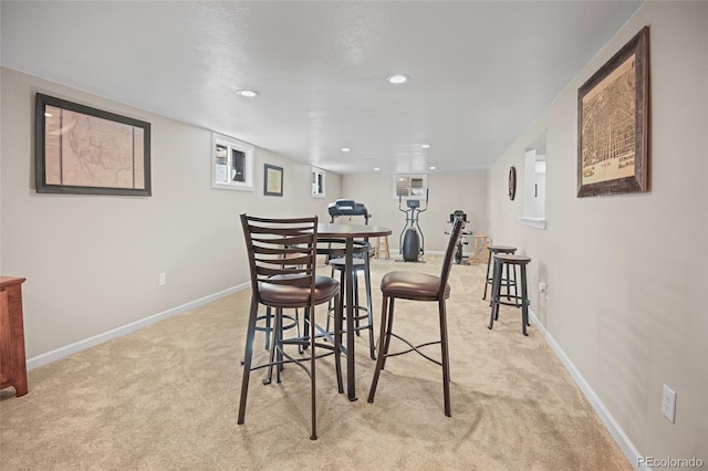 dining room featuring light carpet