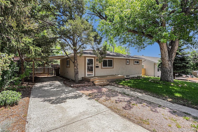 3715 Manchester St, Colorado Springs, CO 80907 - view of front of property with stucco siding, driveway, and a carport
