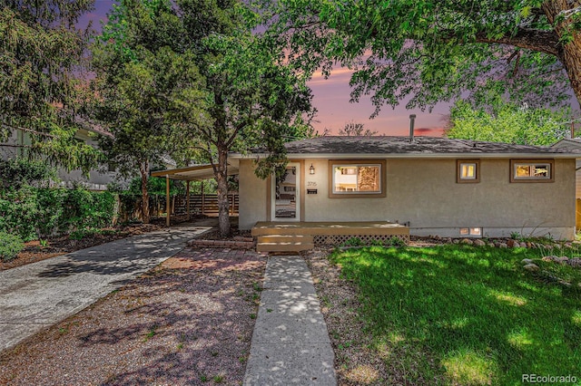 3715 Manchester St, Colorado Springs, CO 80907 - view of front of property with stucco siding, concrete driveway, and a carport