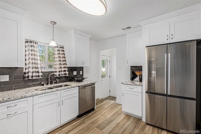 3715 Manchester St, Colorado Springs, CO 80907 - kitchen featuring stainless steel appliances, a sink, backsplash, and healthy amount of natural light