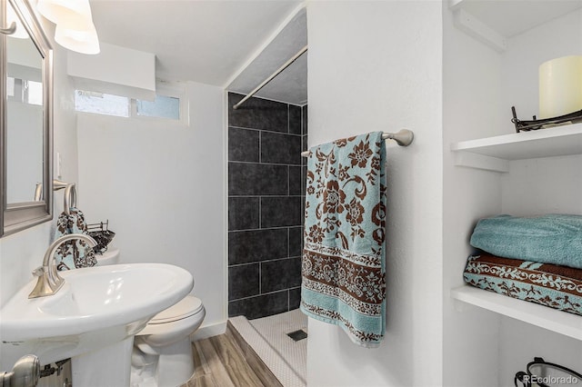 3715 Manchester St, Colorado Springs, CO 80907 - bathroom with toilet, a shower stall, wood finished floors, and a sink