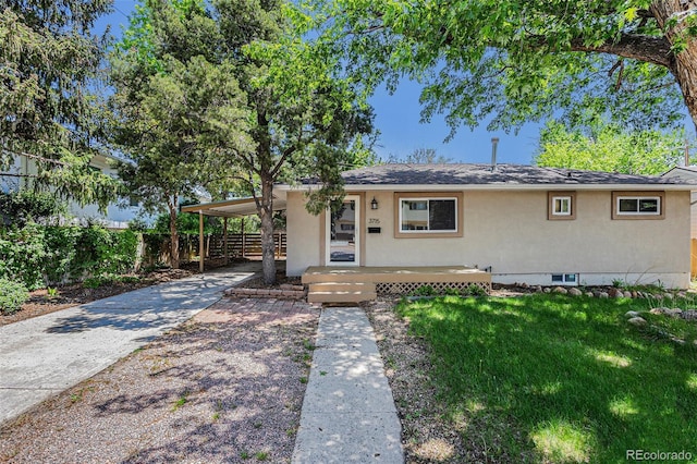 3715 Manchester St, Colorado Springs, CO 80907 - view of front facade with stucco siding, concrete driveway, and a carport