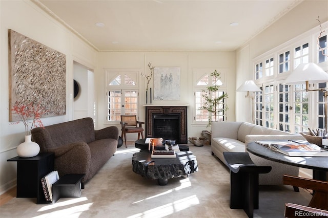 carpeted living room featuring a fireplace and crown molding