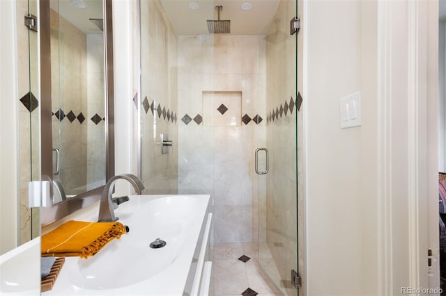 full bath with a shower stall and vanity