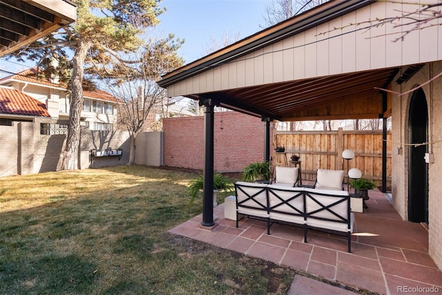 view of yard with a patio area, fence, and outdoor lounge area