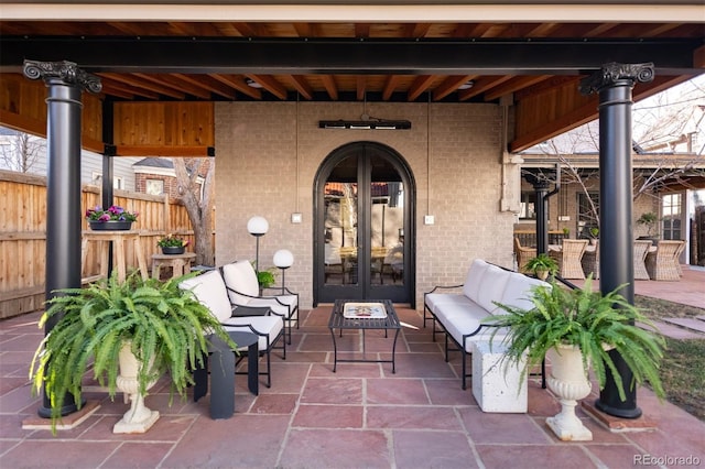 view of patio / terrace featuring an outdoor hangout area, french doors, and fence