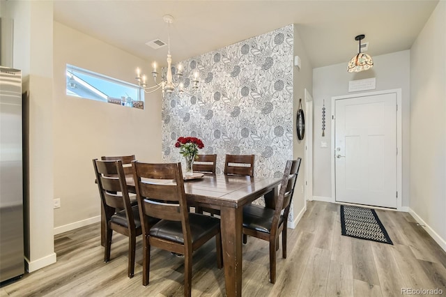 dining room with a chandelier and hardwood / wood-style floors