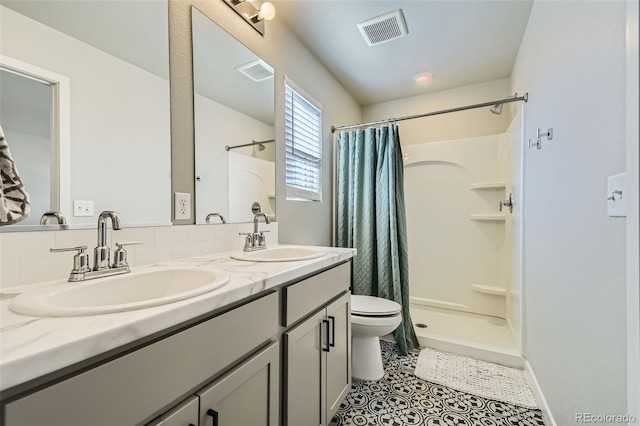 bathroom with vanity, toilet, a shower with shower curtain, and tile patterned floors